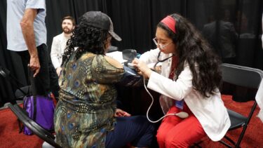Olgaaurora Rodriguez, right, a third-year pharmacy student in the UAMS College of Pharmacy, provided health screenings at the expo. 