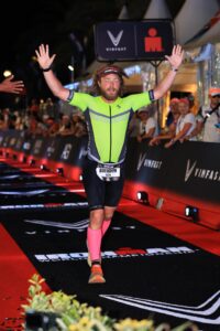 Hogge crosses the finish line at the Ironman World Championship in Nice, France.