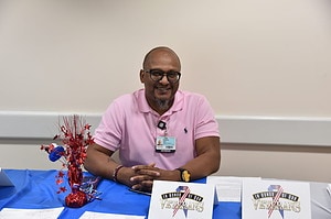 Patrick Lee, executive assistant for women and infant services, volunteers at a collection table during the donation drive. 