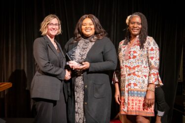 Nakita Lovelady, Ph.D. (center), received the M. Kate Stewart Community Engaged Researcher of the Year Award from TRI Executive Director Christi Madden, MPA (left), and Keneshia Bryant-Moore, Ph.D., APRN, FNP-BC.