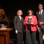 Joyce Raynor, center, executive director of the Center for Healing Hearts & Spirits, receives the Chancellor's Community Engaged Research Partner of the Year Award. She is joined by TRI's (l-r) Tiffany Haynes, Ph.D., and Christi Madden, MPA, and Darlynton Adegor of Healing Hearts & Spirits.