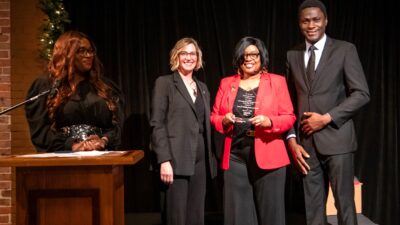 Joyce Raynor, center, executive director of the Center for Healing Hearts & Spirits, receives the Chancellor's Community Engaged Research Partner of the Year Award. She is joined by TRI's (l-r) Tiffany Haynes, Ph.D., and Christi Madden, MPA, and Darlynton Adegor of Healing Hearts & Spirits.