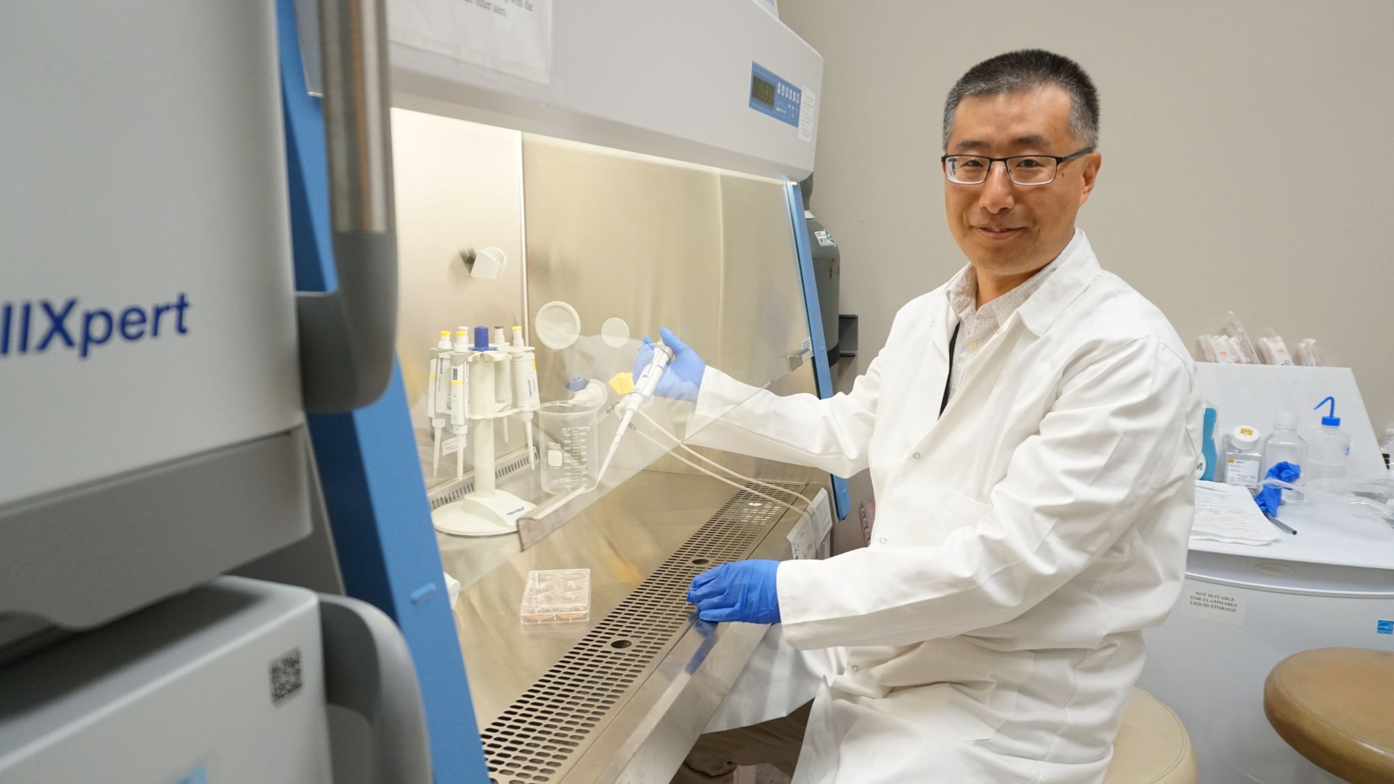 Huiliang Zhang, Ph.D., in his lab at UAMS.