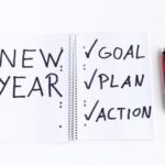 Note pad that says "New Year: Goal, Plan, Action