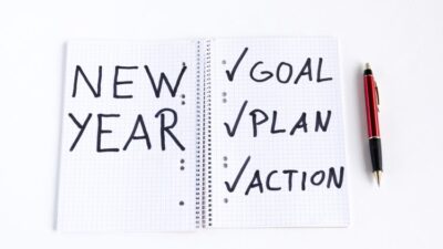 Note pad that says "New Year: Goal, Plan, Action