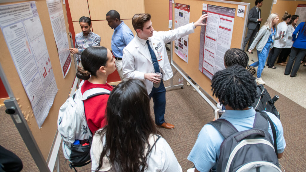 <p>Liam Alderson of the College of Medicine discusses his poster at Student Research Day.</p>
<div><a class="more" href="https://news.uams.edu/2024/03/20/uams-students-shine-in-student-research-day-presentations/uams-student-research-day-2024/">Read more</a></div>