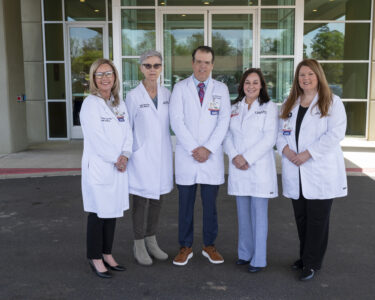 Tiffany Lucas, APRN (from left, shown outside the building); Martha Garrett-Shaver, M.D.; Joseph DeLuca, M.D.; Donya Watson, M.D.; and Julie Wylie, APRN, are now seeing patients at the UAMS Health Family Medical Center.