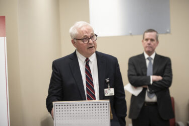 Richard Turnage, vice chancellor for UAMS Regional Campuses, speaks during the ribbon-cutting ceremony as UAMS Chancellor Cam Patterson looks on.