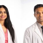 Two UAMS doctors in white coats