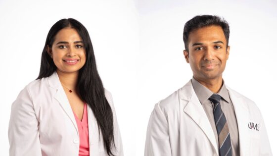Two UAMS doctors in white coats