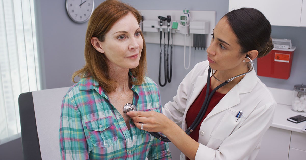 Doctor performing preventive medical diagnosis on patient