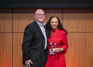 Ron Robertson, M.D., presents the Clinical Excellence-Physician of the Year Award to Ronda Henry-Tillman, M.D. (right).