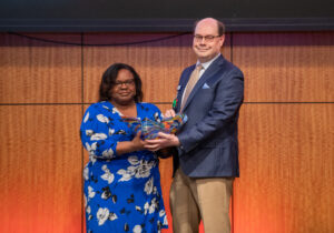 Nominator Chenia Eubanks (left) presents a commemorative art glass bowl to Eduardo Ochoa Jr., M.D., the 2024 Dean’s Distinguished Faculty Service Award honoree (right). Eubanks also was an honoree, receiving the Clinical Excellence Award for Service & Professionalism.