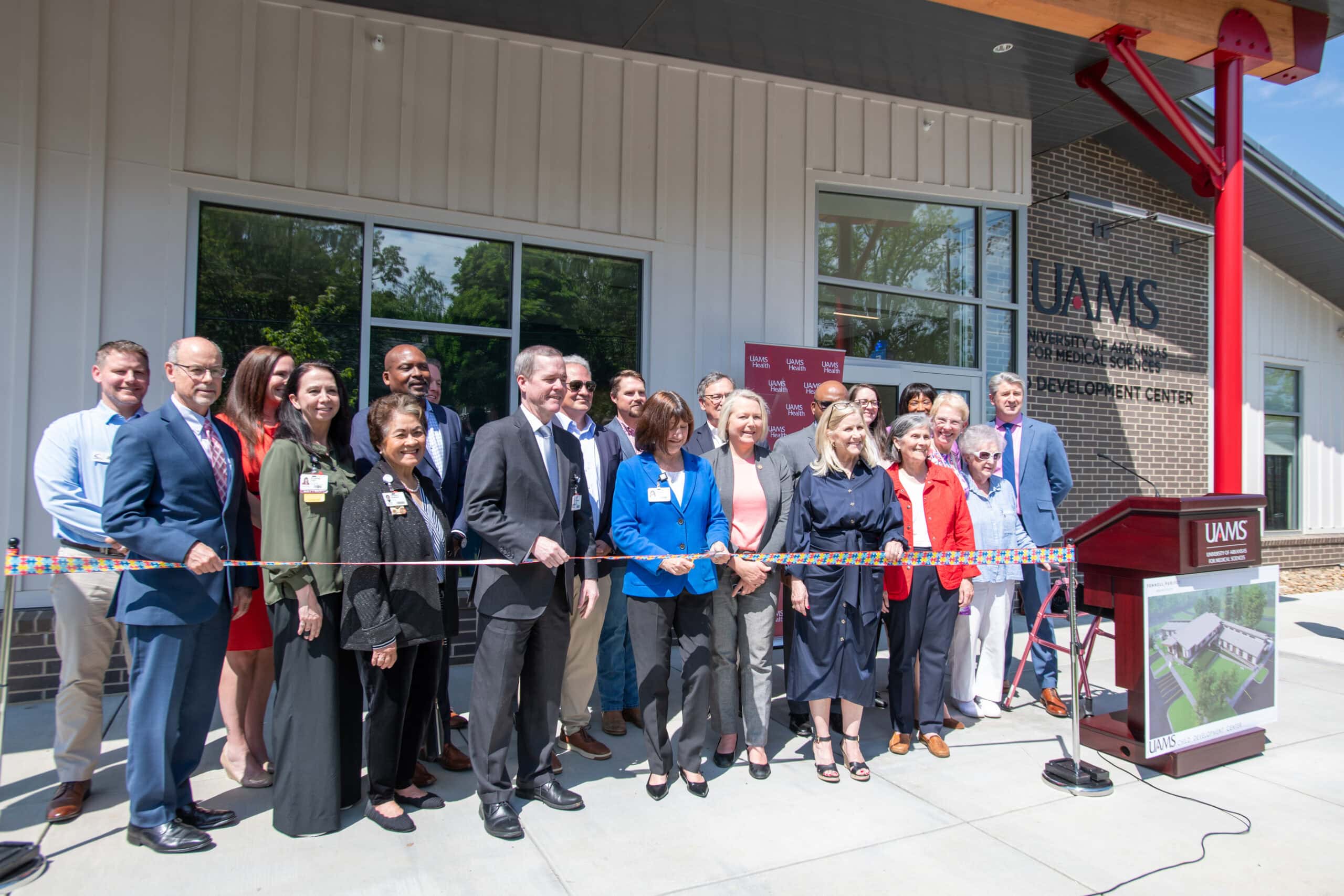 Stephanie Gardner, UAMS provost and chief strategy officer, cuts the ribbon at a ceremony to celebrate the UAMS Child Development Center, which is scheduled to open in early May.