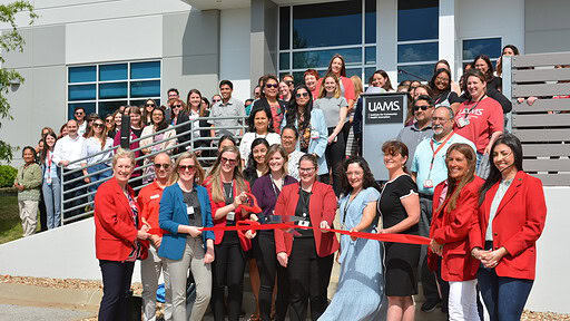 Members of the UAMS Institute for Community Health Innovation and the Springdale Chamber of Commerce cut a ribbon to celebrate the creation of UAMS' 8th institute.