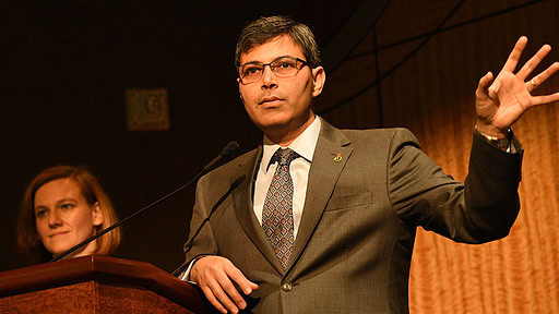 Rohit Dhall, M.D., chair of the UAMS Department of Neurology, discusses Parkinson's disease. Neurosurgeon Erika Petersen, M.D., who founded the annual Parkinson's Symposium, is in the background.