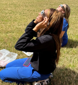 Ce'jae Brown, front, and Morgan Cockrell, look at the partial eclipse moments before the totality.