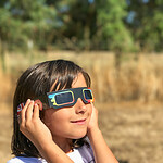 Child wearing eclipse glasses