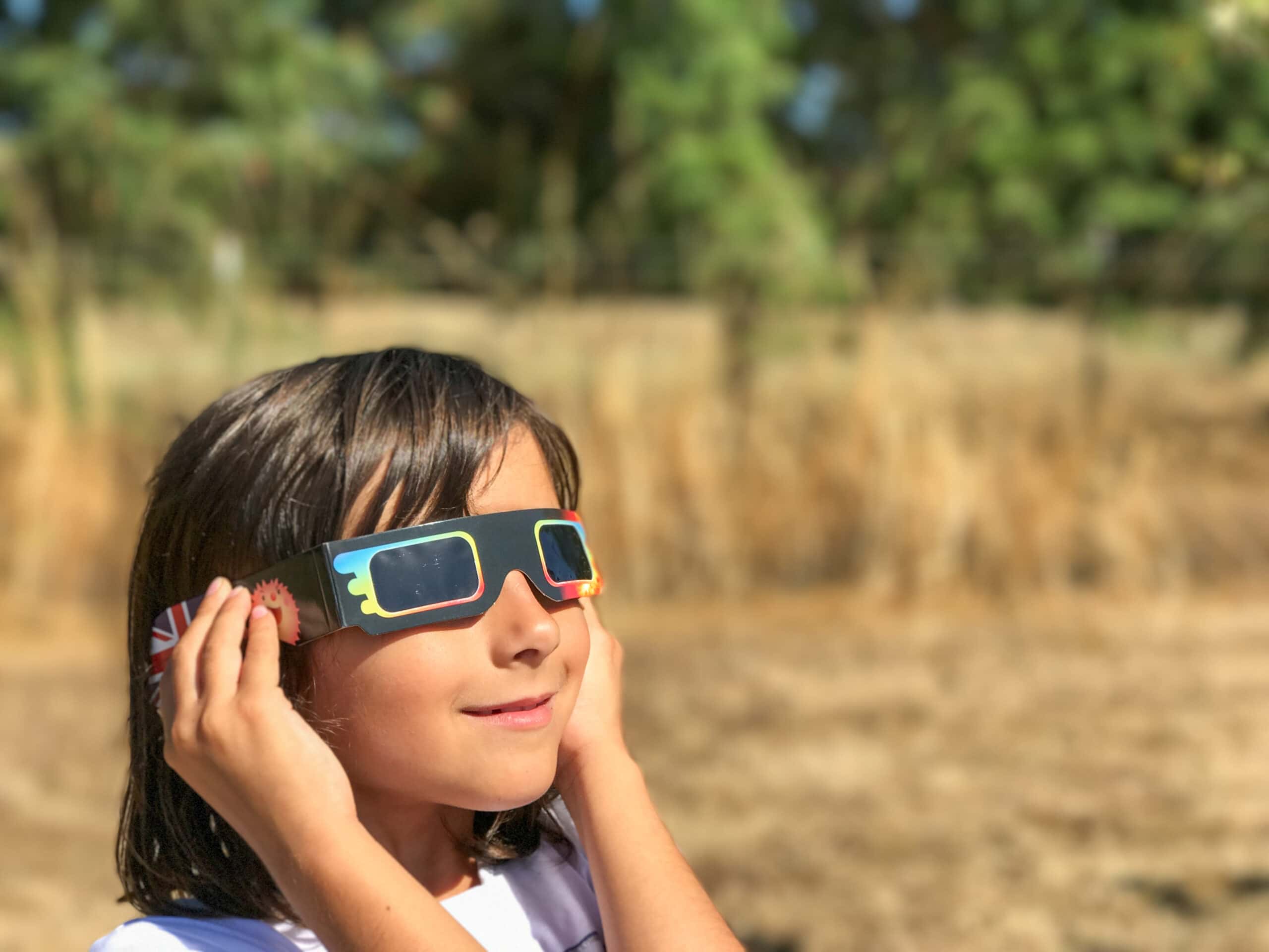 Child wearing eclipse glasses