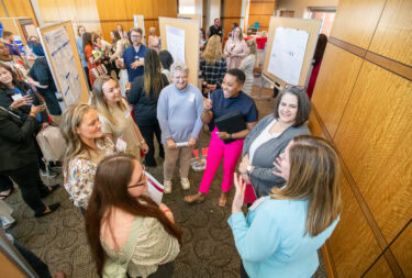 Nursing professionals and students talk about the latest research during poster presentations at the conference.