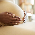 Shot of a mother to be caressing her baby bump