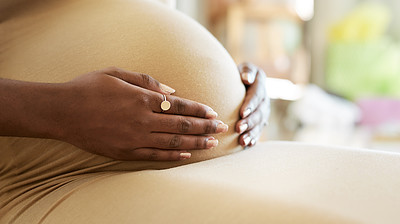 Shot of a mother to be caressing her baby bump