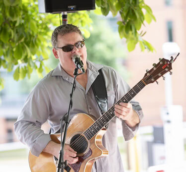 A guitarist performs at the College of Health Professions brunch on the Friday before the 2024 commencement ceremony.