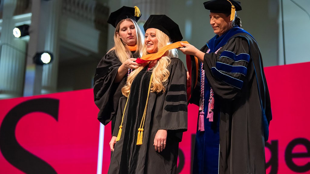 <p>A graduate dons her hood during the UAMS College of Nursing’s hooding and pinning ceremony. </p>
<div><a class="more" href="https://news.uams.edu/2024/05/29/hooding-and-pinning-ceremony-honors-170-graduates-in-uams-college-of-nursing/con-pinning-ceremony-2024-05172024-dsc_0669/">Read more</a></div>