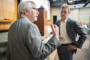 T. Glenn Pait, M.D., a neurosurgeon who is interim director of the UAMS Department of Neurosurgery, talks with Keefe after the lecture.