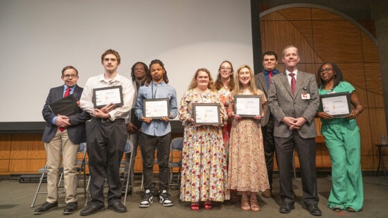 Chancellor Cam Patterson, far right, stops after the ceremony for a photo with the Project SEARCH graduating Class of 2024.