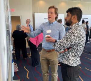 A UAMS scientist shares his research at the poster session 
