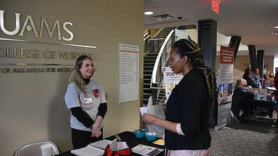 Lela Brown (right), a student in the Doctor of Nursing Practice (DNP) Nurse Practitioner program, talks with Caitlin Tidwell, program manager for the UAMS College of Nursing, during a January job fair organized through the Advanced Nurse Education Workforce Grant.
