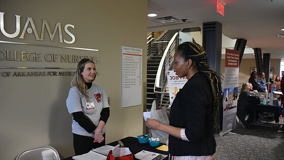 Lela Brown (right), a student in the Doctor of Nursing Practice (DNP) Nurse Practitioner program, talks with Caitlin Tidwell, program manager for the UAMS College of Nursing, during a January job fair organized through the Advanced Nurse Education Workforce Grant.