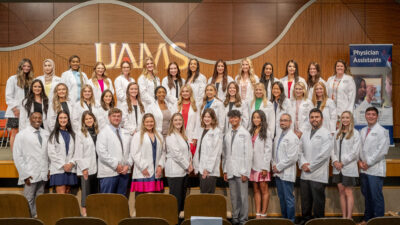 The 40 members of the Physician Assistant Studies Class of 2024 gather on stage in Smith Auditorium for group portrait.