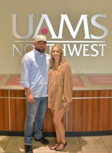 Greenwood police officer John Michael O’Mara poses with his wife on the UAMS Northwest Campus in Fayetteville.