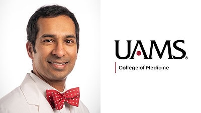 white-coat portrait of Dalvi with UAMS logo