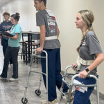 Students with walkers participating in a medical education exercise
