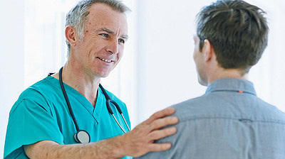 Male doctor conferring with male patient