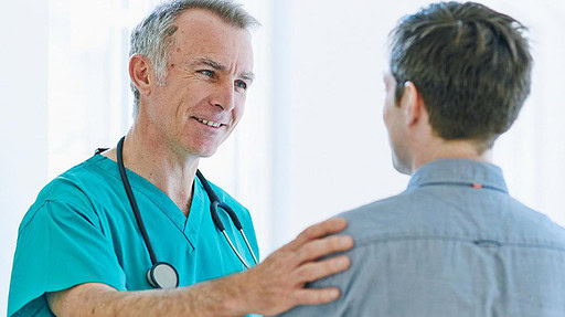 Male doctor conferring with male patient