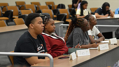 Chris Carlock (left) and other students in the HCOP Academy take part in a session on public health issues. The teens later drafted and filmed a series of public service announcements that covered topics such as mental health, opioids, pollution, sexually transmitted illnesses and vaping.