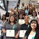 College of Health Professions students hold certificates of scholarship while gathering on the lobby stairs in the Rahn Education Building after a scholarship reception that recognized scholarship donors and student recipients.