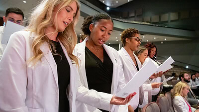 Grace Booker, Kennedi Burns, Kia Bursey-Walker reciting professionalism pledge