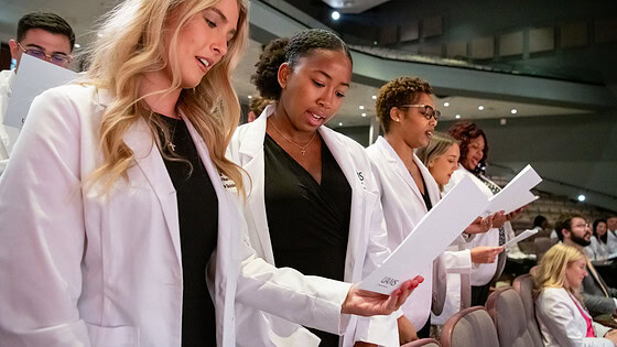 Grace Booker, Kennedi Burns, Kia Bursey-Walker reciting professionalism pledge