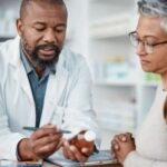 Woman speaking to a pharmacist about medications