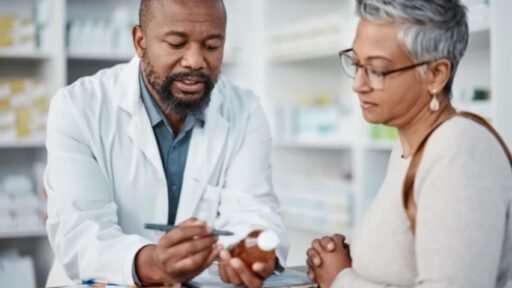 Woman speaking to a pharmacist about medications