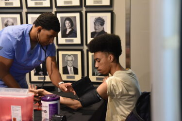 A student from Philander Smith University has his blood pressure checked at the Public Health Summit. UAMS preceptors and students offered a variety of screenings and health resources for the attendees.