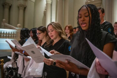 College of Nursing students recite the Nightingale Pledge, which affirms their dedication to maintaining professional standards and promoting the health and happiness of their patients.