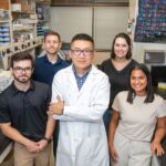 Lu Huang, Ph.D., center, with his lab team at UAMS (front, l-r): J. Tucker Andrews and Ananya Ranaraja; and (back, l-r): Grant Dawson and Jilliyn Jeu.