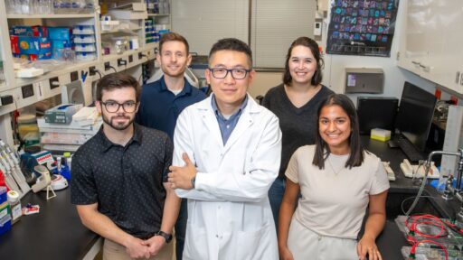 Lu Huang, Ph.D., center, with his lab team at UAMS (front, l-r): J. Tucker Andrews and Ananya Ranaraja; and (back, l-r): Grant Dawson and Jilliyn Jeu.