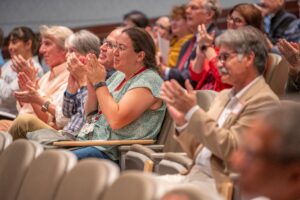 Audience members applaud Michael Jennings, Ph.D., for his service and his words of wisdom. 